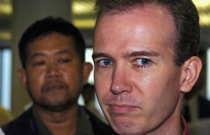 US teacher John Mark Karr (R) looks on a